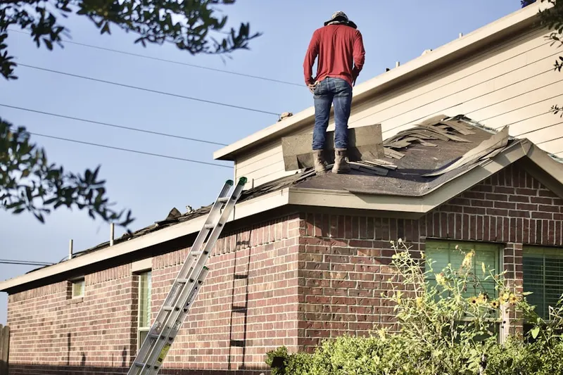 Professional roofer working on a residential roof in Magna